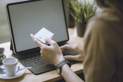 Midsection of woman using mobile phone
