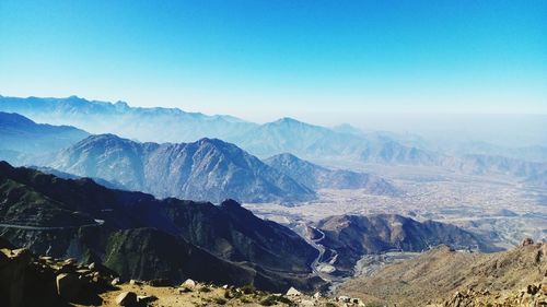 Scenic view of mountains against clear blue sky