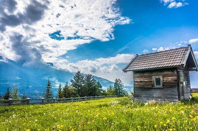 Scenic view of grassy field against cloudy sky