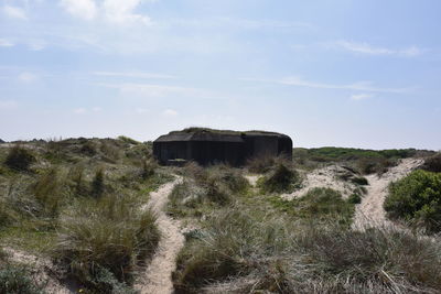 Built structure on landscape against sky