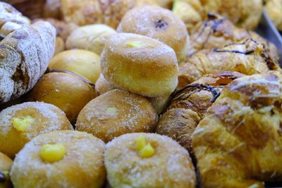 Italian pastries, croissants and zeppole, deep-fried dough ball, topped with powdered sugar