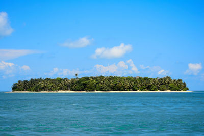 Scenic view of sea against blue sky