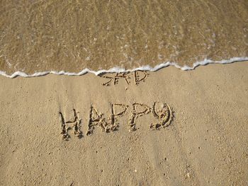 High angle view of text on beach