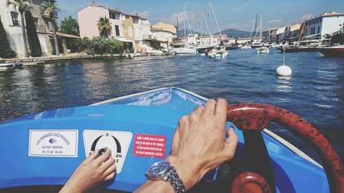 Low section of woman on boat in sea