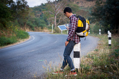 Full length of man photographing while standing on road