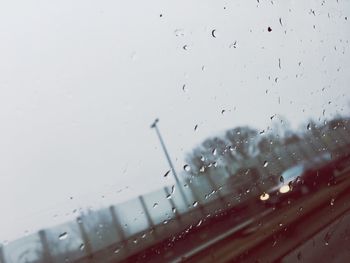 Close-up of water drops on car windshield during rainy season