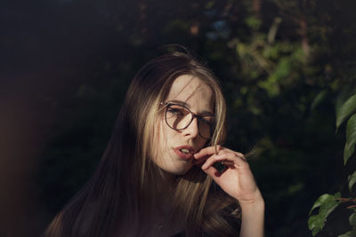 Portrait of young woman smoking cigarette