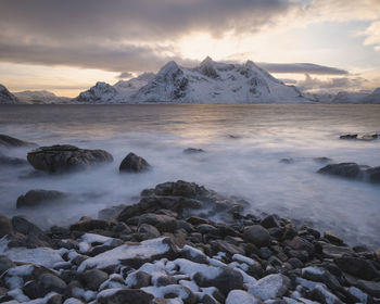 Scenic view of snowcapped mountains against sky during sunset