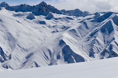 Scenic view of snow covered mountains against sky