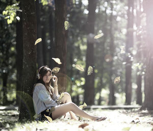 Side view of young couple sitting on land