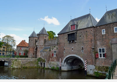 Arch bridge over river against sky