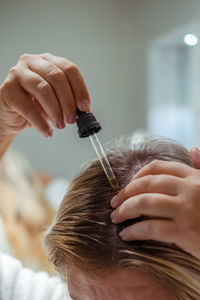 Cropped image of man repairing hair