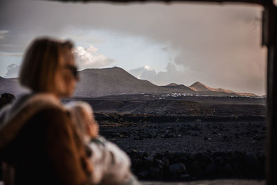 Rear view of woman looking at mountains