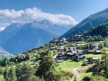 Scenic view of mountains and houses against sky