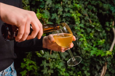 Midsection of man drinking glass