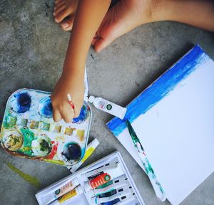 Cropped image of kid painting on paper