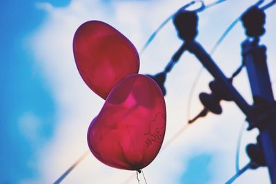 Low angle view of red umbrella against sky