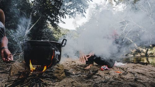 Smoke emitting from log on barbecue grill
