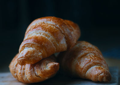 Close-up of bread on table against black background