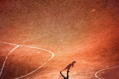 Low section of boy walking on sports track