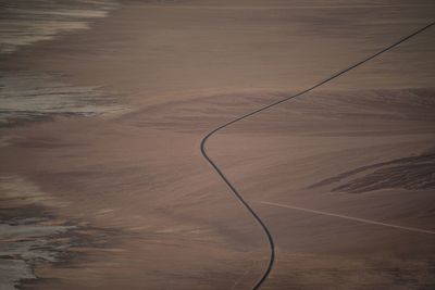 High angle view of road amidst land against sky