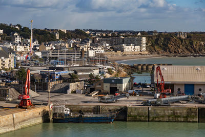 View of town by sea against sky