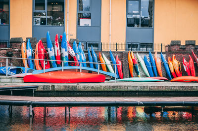 Multi colored boats by canal in city