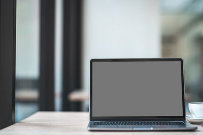Close-up of laptop on table at home