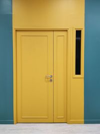 Yellow door on green wall