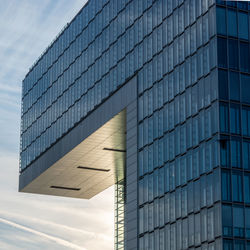 Low angle view of modern building against blue sky