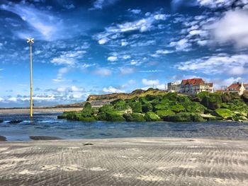 Buildings against cloudy sky