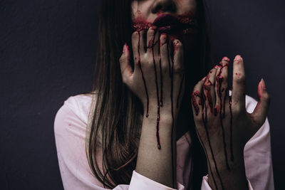 Portrait of woman against black background