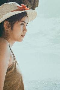Portrait of young woman looking at sea