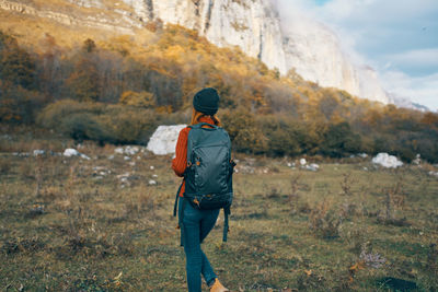 Rear view of man walking on landscape