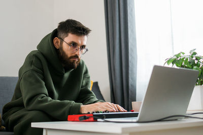 Young man using laptop at office