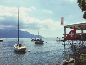 Sailboats on sea against sky