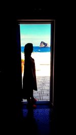 Rear view of woman looking at camera