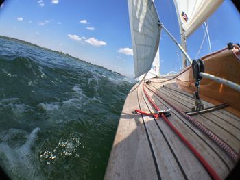 Sailboat sailing on sea against sky