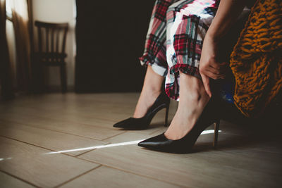 Low section of woman sitting on floor