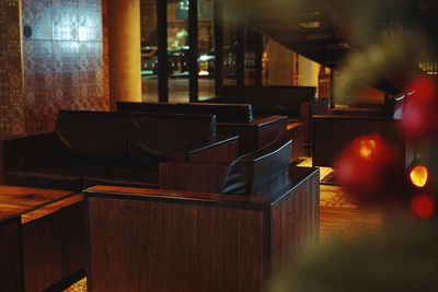 Empty chairs and tables in illuminated room , christmas 