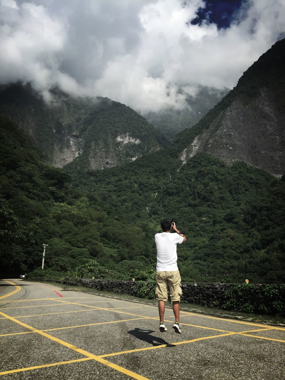 mountain, rear view, full length, lifestyles, road, sky, leisure activity, walking, casual clothing, men, cloud - sky, standing, street, mountain range, person, the way forward, backpack, landscape