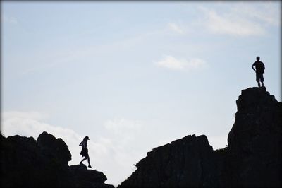 Low angle view of man standing on cliff