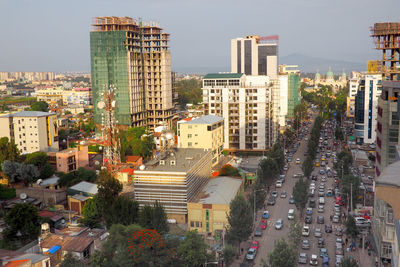 High angle view of city street and buildings against sky