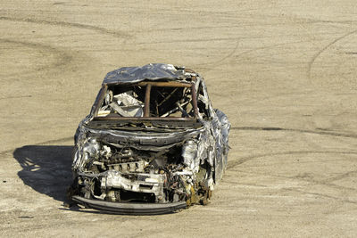 High angle view of abandoned car on field