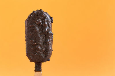 Close-up of ice cream against orange background