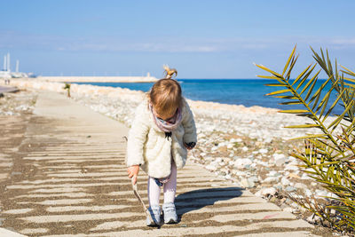 Rear view of boy on beach