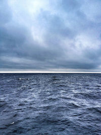 Scenic view of sea against cloudy sky