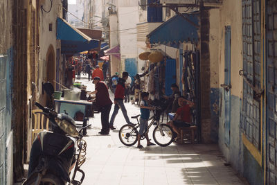 People riding bicycles on street in city