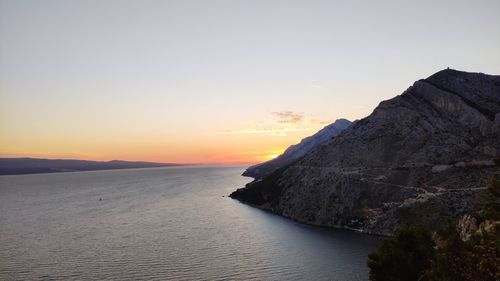 Scenic view of sea against clear sky during sunset