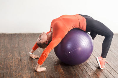 Side view of young woman lying on floor